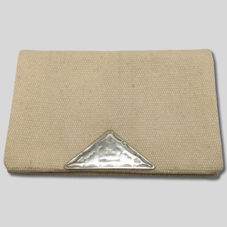 Photo of Beatrix Farrand's white wool purse with an etched sterling triangle clasp, made by Fred Harvey.
