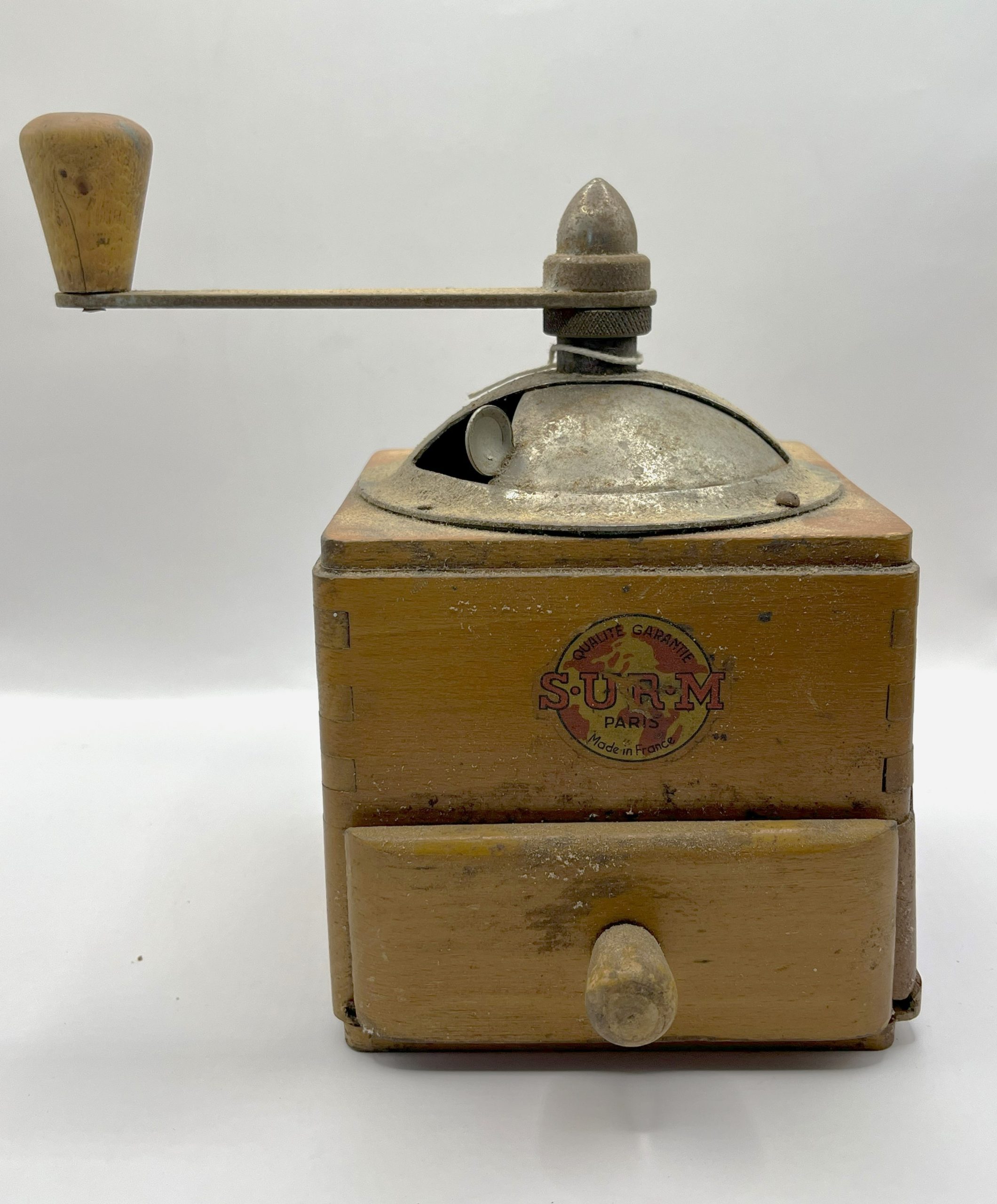 Coffee grinder with wooden box for beans, metal handle and wood drawer for founds. Made by "S.U.R.M Quality Garantie Paris Made in France."