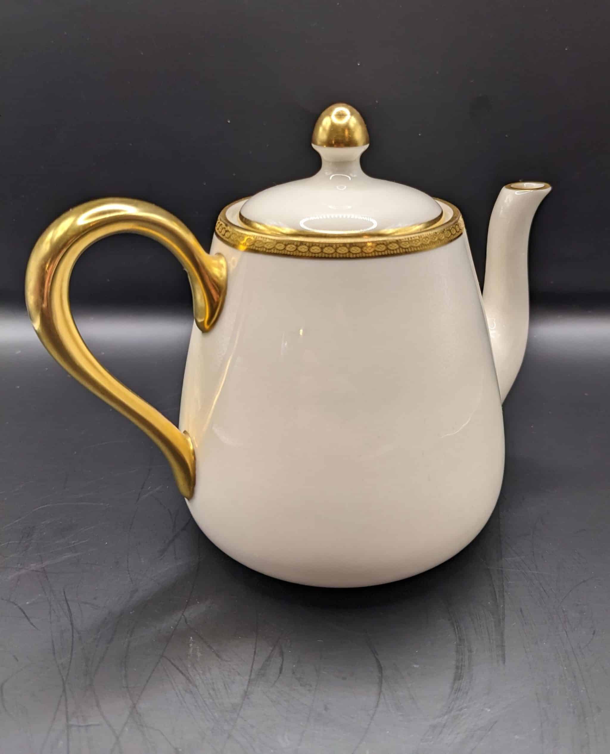 Lenox china coffee pot. White with gilded edges and handle. Circa 1900 - 1920.