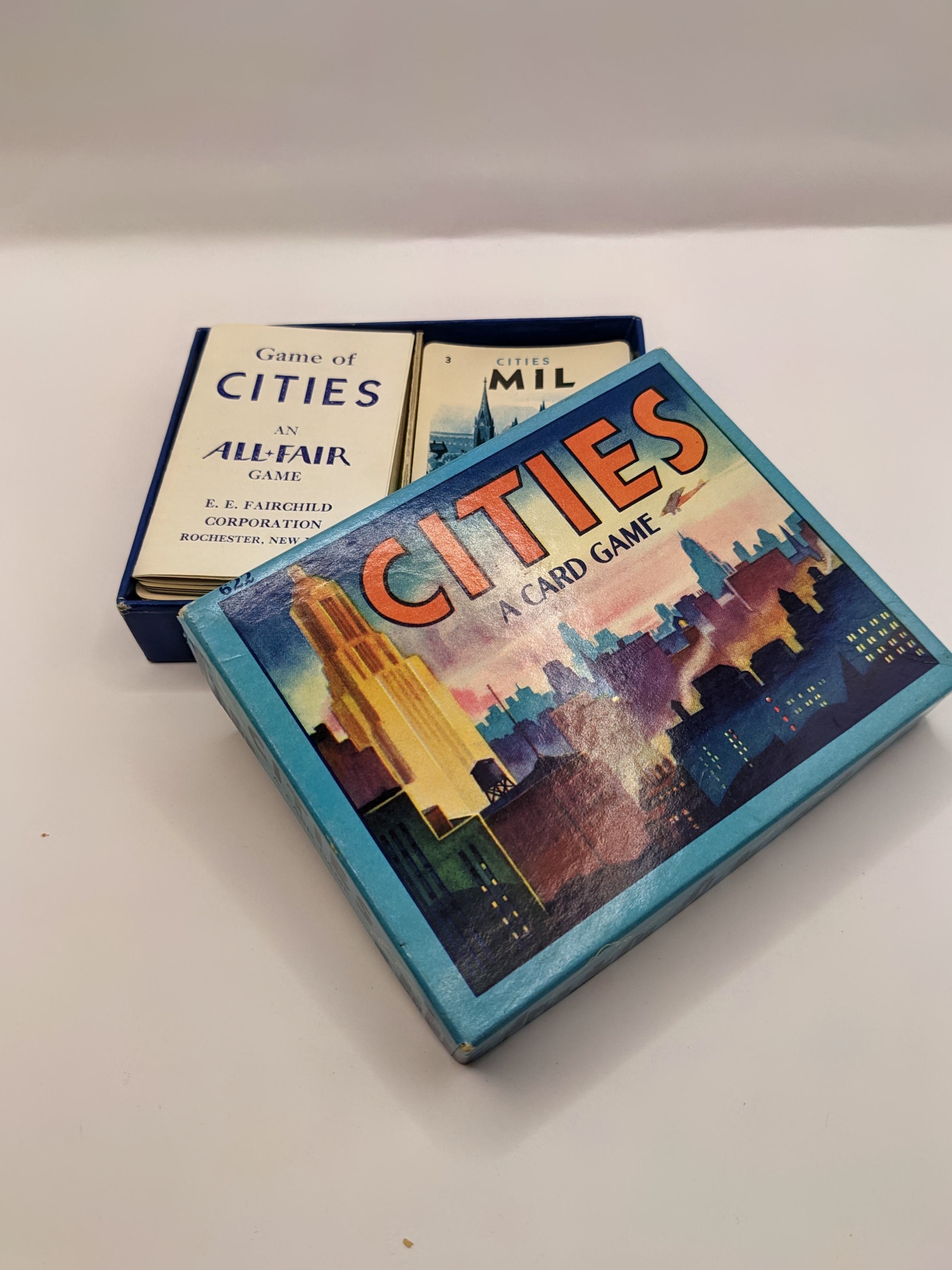 Photo of the mid-century "Cities: A Card Game." The box is open to show the rule booklet and a stack of city cards.